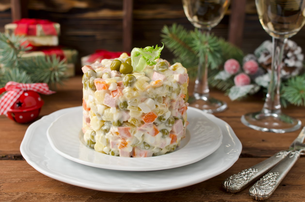 Russian traditional salad Olivier with vegetables and meat